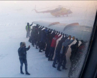Watch: Passengers push frozen Siberian plane