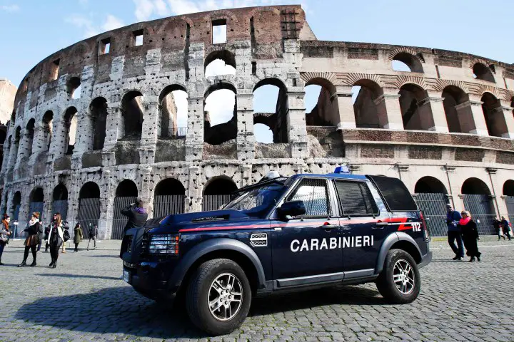 A carabinieri paramilitary car patrols in front of the Colosseum in Rome