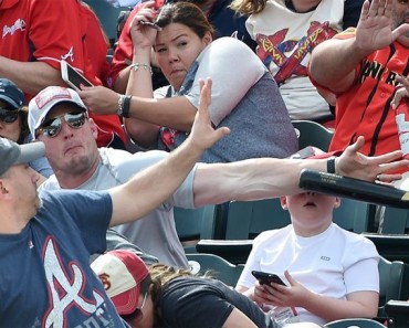Dad Saves Son and Photo Goes Viral. Look at Him Compared to other Fans Around Him.