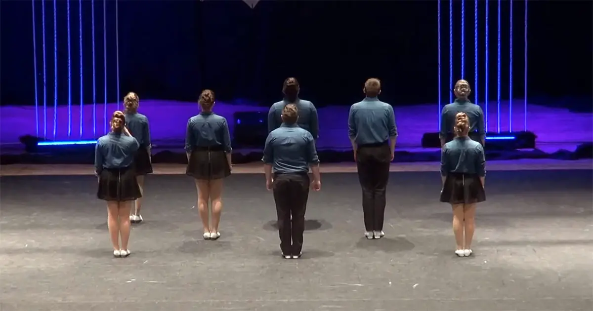 8 Cloggers Line Up On Stage, Moments Later They Spin Around and The Crowd Goes Nuts