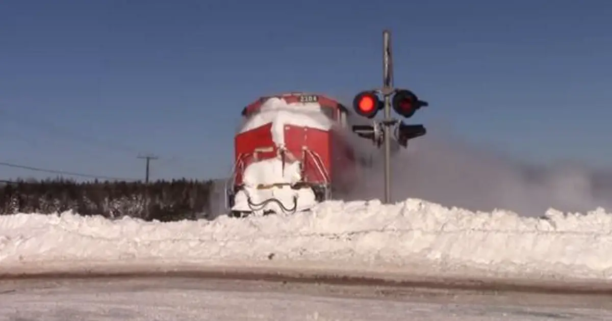 Man Films Train Barreling Down Tracks, Captures Stunning Moment It Collides with Wall of Snow